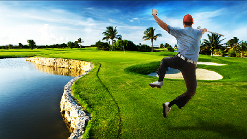 Golfer Jumping For Joy In Dramitic Hole Setting